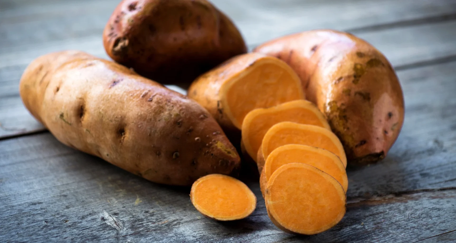 sweet potato plant with leafy vines growing in soil