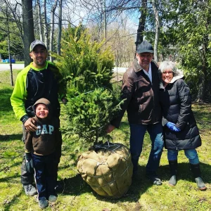 Client receiving first free tree from community planting program